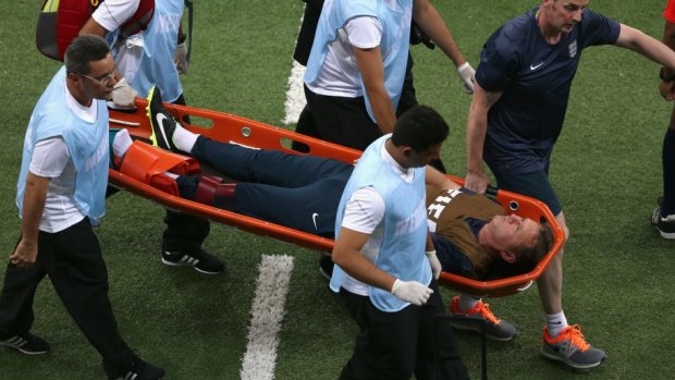 England trainer Gary Lewin is stretchered off the field.