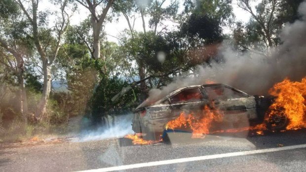 A burning car on the Kings Highway sparked a small fire in nearby bushland.