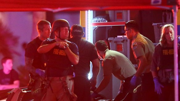 Medics treat the wounded as Las Vegas police respond to a shooting on the Las Vegas Strip on Sunday.