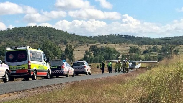 Emergency crews arrive at the scene where a light plane landed on the Capricorn Highway, about 25 kilometres south-west of Rockhampton.