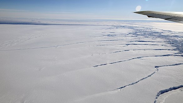 Great rifts are visible beneath the wing of a NASA aircraft flying over a glacier feeding the Amundsen Sea.