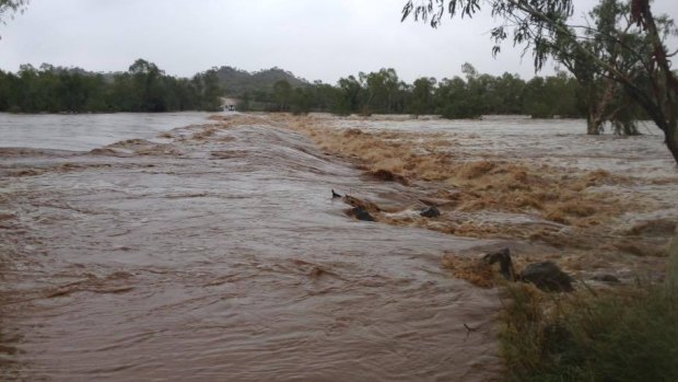 A bridge at Cloncurry, in Queensland's north west, is inundated after the region received 38mm in the four hours to 9am on Monday.