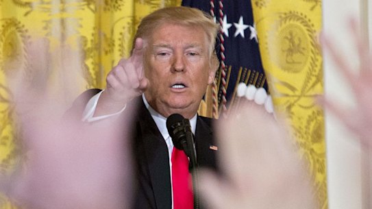 U.S. President Donald Trump takes a question from members of the media during a news conference.
