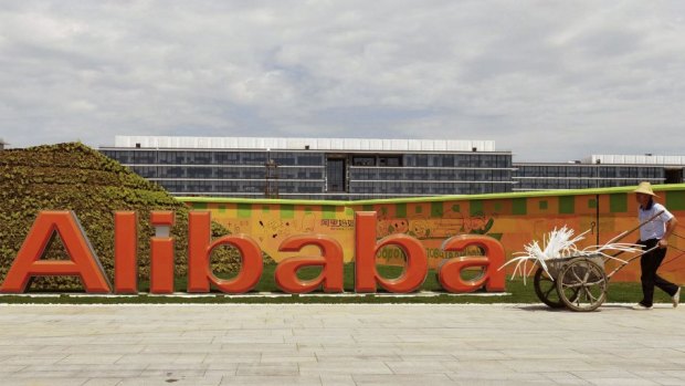 A worker walks past the Alibaba headquarters on the outskirts of Hangzhou, Zhejiang province, China.