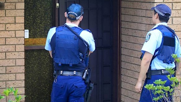 Police officers at the home of the 16-year-old boy. 
