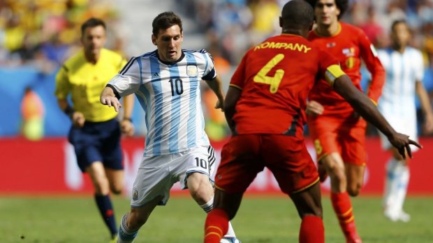 Argentina's Lionel Messi fights for the ball with Belgium's Vincent Kompany.