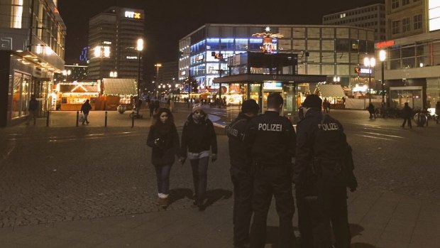 Police conduct checks on the streets of Berlin after a truck crashed into a market crowd in a suspected terror attack.