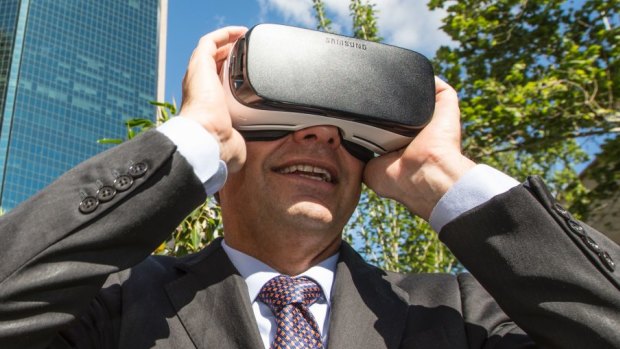 The Assistant Minister for Cities and Digital Transformation, Angus Taylor, looks at a virtual reality version of Circular Quay in 2037 at the Future Street Project.