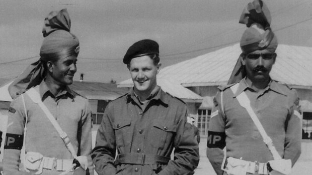 Ian Stewart (centre) flanked by United Nations military police during a press tour of Panmunjom, Korea in 1953.
