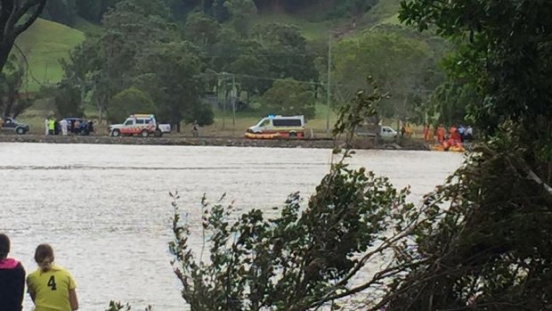 Emergency crews search the Tweed River near Tumbulgum for a missing car.