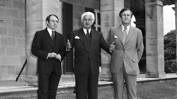 Prime Minister Malcolm Fraser (right) with governor-general John Kerr (centre) and John Howard on the lawns of Admiralty House after the swearing in of Mr Howard as the new treasurer in 1977.