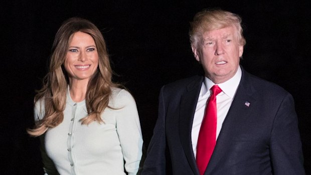 President Donald Trump and first lady Melania Trump walk from Marine One across the South Lawn to the White House in Washington on their return from Italy on Saturday.