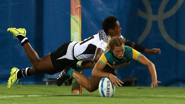 Try time: Emma Tonegato dives to score a try under pressure of Luisa Tisolo of Fiji.