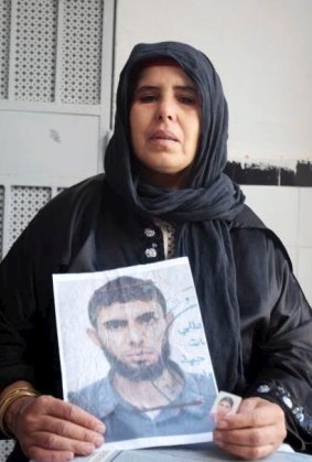 Bilel Kaabi's mother holds up a picture of her son, who was radicalised at a mosque in Tunisia. 