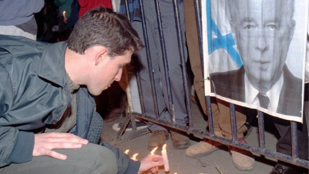 An Israeli places a candle in front of a portrait of Yitzhak Rabin outside his  Jerusalem residence on the morning after his assassination - Sunday, November 5, 1995. 