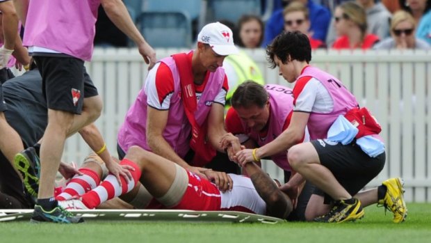 Buddy back: Lance Franklin is treated on the field on Sunday.