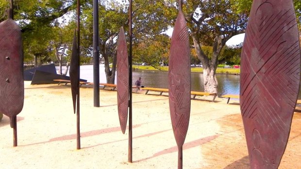 A riverside series of art installations including a forest of oversized rust-coloured metal shields and spears. 