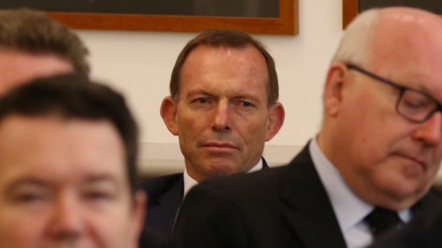 Dean Smith (front left) and Tony Abbott listen to Prime Minister Malcolm Turnbull during a Liberal party room meeting in November.