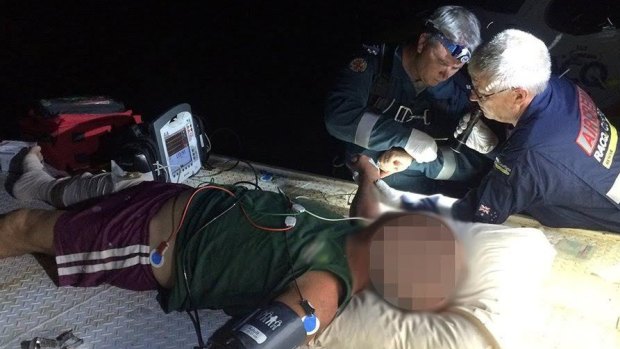 Paramedics treated the bitten man on the back of a ute.