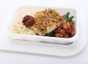 A tasty economy-class dish: Spiced, crusted kingfish with eggplant and capsicum relish, served with green beans and rice.
