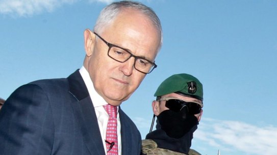 Prime Minister Malcolm Turnbull examines some military hardware during a media conference at Holsworthy Barracks on Monday.
