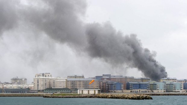 Smoke billows behind residential buildings following an explosion in Gibraltar.