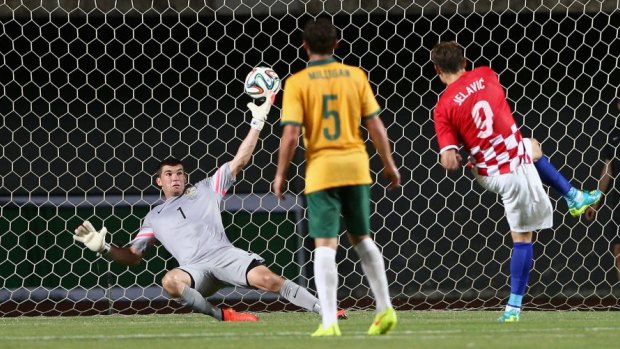 Deadlock broken: Nikica Jelavic of Croatia scores a goal past Socceroos goalkeeper Mat Ryan.
