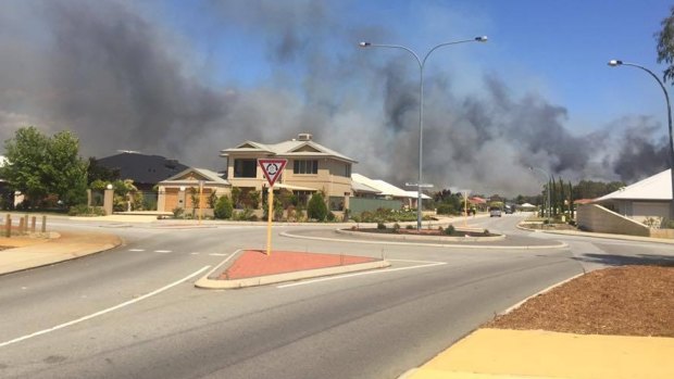 A bushfire in Kenwick was threatening lives and homes on Monday.