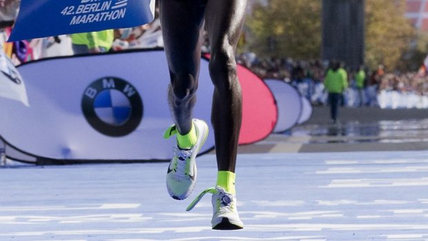 Got sole: Eliud Kipchoge crosses the finish line to win the Berlin Marathon.

