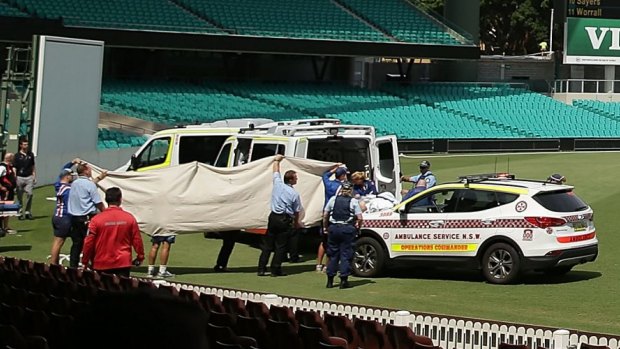 Paramedics treat Phillip Hughes at the Sydney Cricket Ground on Tuesday.