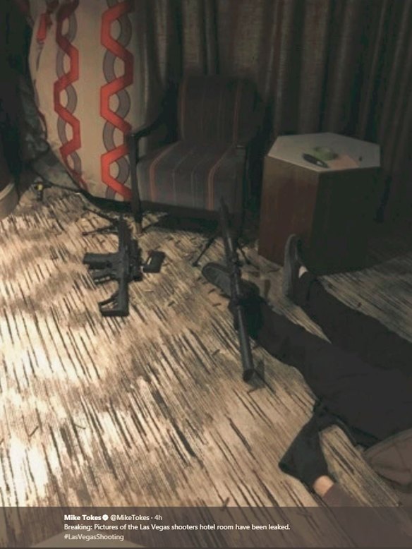 Photos from inside the hotel room show an arsenal of assault rifles and the gunman wearing black gloves.