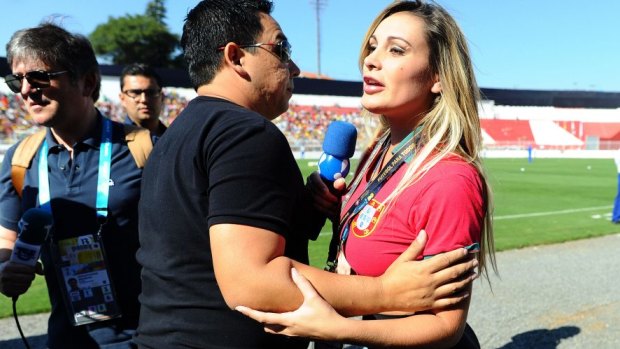 Former MissBumBum contestant, Andressa Urach, is stopped at Portugal's training session in Sao Paulo.