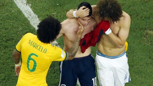 James Rodriguez is comforted by Brazilians Marcelo and David Luiz.