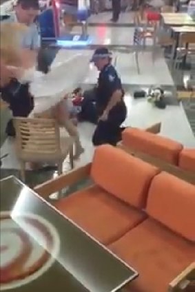 Police arrest a man and woman at Sunnybank Plaza shopping centre.