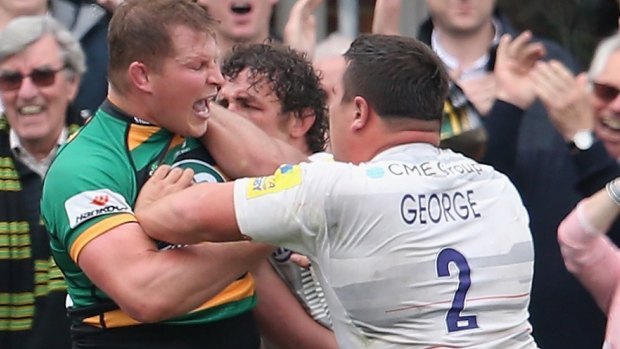 Dylan Hartley (left) tussles with Jamie George (right) and Jacques Burger of Saracens.