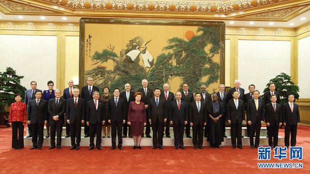 Xi Jinping (centre) and Chau Chak Wing (front row, far right) pictured when Xi met with guests to Imperial Spring Forum 