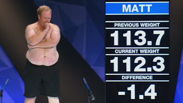 Contestant Matt, from the 2014 season of <i>The Biggest Loser</i>, next to the giant screen used in studio weigh-ins.