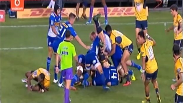 Brumbies player David Pocock is tipped on to his head by Stormers players Schalk Burger and Juan de Jongh in a Super Rugby match