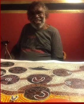 Japaljarri with one of his paintings.