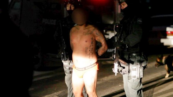 Kemel Barakat, pictured here under arrest in a police raid in 2013, was shot dead in his Mortlake flat.