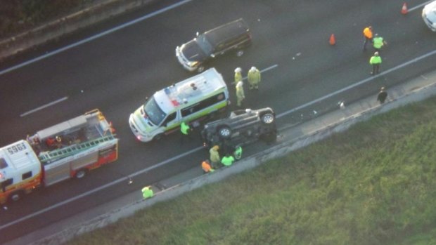 Emergency services at the scene of a rollover on the M1 northbound at Loganholme.