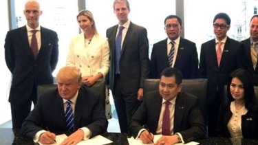 With his children Ivanka and Eric Jr behind him, Donald Trump, front left, signed a Bali hotel management agreement with Hary Tanoesoedibjo, front centre, in 2015.
