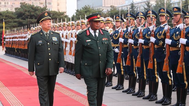 Zimbabwean military chief Constantino Chiwenga, right, inspects Chinese troops in Beijing with General Li Zuocheng during his visit earlier this month.