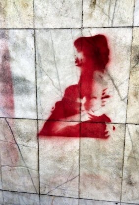 A stencil on a Cairo wall shows the moment that activist and poet Shaimaa al-Sabbagh was shot and died in a colleague's arms.