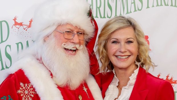Olivia Newton-John, right, and Santa Claus, in Hollywood. She and John Farnham have released a Christmas album this year.  