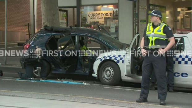 A driver rammed a car into police on Bourke Street on Tuesday, police said. 