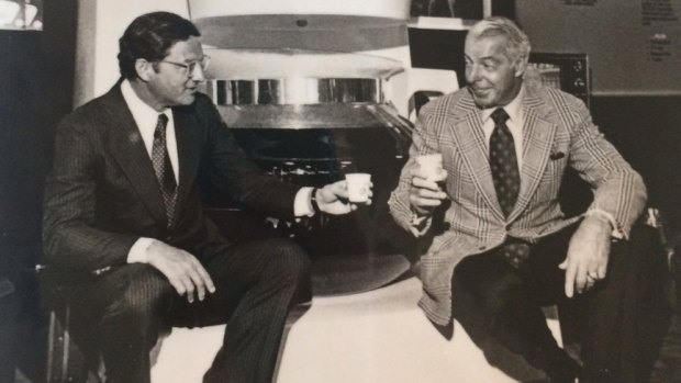 Vincent Marotta, left, and Joe DiMaggio sitting on a large Mr. Coffee machine in Chicago. 