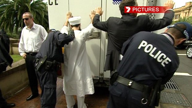 Morrow, left, and Chas Licciardello are detained by police during APEC, in September 2007.