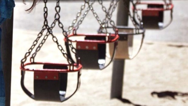 A mother was found pushing her dead son on a park swing.