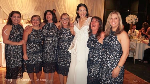 Six of the best: Debbie Speranza, to the left of bride Julia Mammone, and the others wearing the same dress share a laugh.